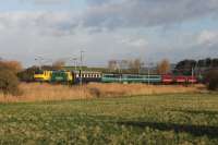 A special ECS movement from Glasgow to Burton-on-Trent, presumably conveying coaches that had been used on the Forth Bridge extra services, makes a colourful spectacle as it heads south through Hest Bank behind Freightliner 90045. Rather unusually for December 2015 the train passed Lancashire in bright sunshine.   <br><br>[Mark Bartlett 23/12/2015]