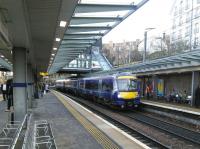 A Glasgow Queen Street service at Haymarket on the last Saturday before Christmas, a day when 'Standing room only - apologies' appeared below every other departure. Because of late running this particular service was running non-stop to Queen Street. Those of you who are old enough (and I suspect that's most of you) will remember push-pull days when this was the norm, with every other train calling only at Falkirk High. That wouldn't do now.<br><br>[David Panton 19/12/2015]