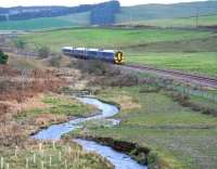 The southern approach to the village of Heriot on 19 December 2015. The approaching train about to pass below the bridge carrying the new A7 link road (just off picture to the right) is the 1331 ex-Tweedbank.<br><br>[John Furnevel 19/12/2015]