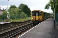 A Merseyrail service from Hunts Cross to Southport approaches Ainsdale station on 26 June 2011. The height of the unused section of the Up platform is considerably lower than the rest.<br><br>[John McIntyre 26/06/2011]