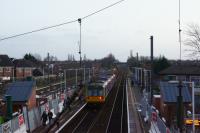 A Blackpool to Manchester service calls at Leyland in the late afternoon of 21 December 2015. Of note on the platforms is the appearance of equipment huts on each platform for the lifts that are being installed along with new footbridge. All three lift towers have started to be constructed using a series of prefabricated concrete sections, the remainder of them remain in the station car park. The bridges and steps are scheduled to be craned in on Christmas and Boxing days whilst the lines are closed.<br><br>[John McIntyre 21/12/2015]