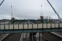 Look what Father Christmas has left! With the railway closed for Christmas Day and Boxing Day, a new footbridge and two of the three lift shafts had appeared by early afternoon. By end of the day the third lift shaft had been craned into position and each had a roof. In the foreground is the old footbridge which will be removed during 2016. Even with atrocious weather conditions that the workforce had to endure during the day, it appears that very good progress has been made. <br><br>[John McIntyre 25/12/2015]