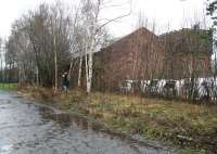 Scene at St Boswells on 26 December 2015, with the late running 1410 (Boxing Days only) eejit to Tweedbank about to depart in heavy rain. Note the surviving locomotive shed and water tank to the right, on land now occupied by a van rental company.  [see image 28832].<br><br>[John Furnevel 26/12/2015]