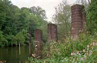 The piers of the line which carried the Caledonian Railway's Anniesland Gas Works branch from Dawsholm across the River Kelvin in a view looking to Anniesland in 1988. The Kelvin Aquaduct lies just beyond and the Caley's short lived Dawsholm station is off to the right.<br><br>[Ewan Crawford //1988]