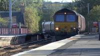 6G08 Hunterston - Longannet loaded coal hoppers passing through Coatbridge Central on 29 September 2015. DBS class 66 No 66165 is in charge.<br><br>[Ken Browne 29/09/2015]