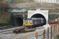 A Blackpool to Huddersfield (via Manchester Victoria) service exits the southern portal of the new Farnworth Tunnel on 23 December 2015. On the left there is still track in place through the old small bore tunnel which had been used for all services for 7 months but it is no longer connected. A normal timetable was resumed on 14 December after the Down line was connected up.<br><br>[John McIntyre 23/12/2015]