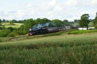 Ex LMS Black 5 no. 45231 drifts through the site of Rimington station between Gisburn and Chatburn in the Ribble Valley on 22 July 2015. The loco was hauling the return leg of The Fellsman railtour from Carlisle to Lancaster. The remains of the platform are between about the second to the fifth carriage. The station house is to the right and is a private residence.<br><br>[John McIntyre 22/07/2015]