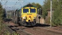 Freightliner 66550 passes through Coatbridge Central on 29 September with Longannet - Hunterston empties.<br><br>[Ken Browne 29/09/2015]