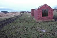 View east at Gass Water Branch Junction in 2005. The Muirkirk line runs straight ahead and the branch was to the right of the remaining structures. Spelling of Gass Water varies with Gaswater, Gas Water, Gasswater and Gass Water all in use.<br><br>
The rump of the Muirkirk line remained open to this junction to serve Cairnhill (on the Gass Water branch) until 1976. [See image 53735] for Bill Roberton's view of the exchange sidings two years before closure.<br><br>
The Wellwood Opencast loading Disposal Centre was more than two miles east of here and on the main line, not the Gass Water branch and not related to Cairnhill.<br>
<br><br>[Ewan Crawford 20/02/2005]