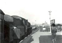 Platform view east at Whifflet Upper station on 1 August 1961 with a train recently arrived from Maryhill Central. The locomotive is Motherwell shed's Standard class 4 2-6-0 no 76000.<br><br>[G H Robin collection by courtesy of the Mitchell Library, Glasgow 01/08/1961]