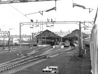 Looking back from a class 86 hauled London - Glasgow train passing through Rugby in the summer of 1969. An outer suburban class 310 emu can just be seen on the far side of the station while a class 08 is duty station pilot.<br><br>[John Furnevel 30/06/1969]