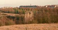 One of the two central piers remains of the double track Calderbank Viaduct which was closed to traffic around 1941 leaving Chapelhall at the end of a branch from Lanridge Junction. The viaduct passed over the Ballochney Railway's branch to Calderbank Steelworks and an extension of the Caley's Thankerton Colliery branch which served the Calderbank Steelworks and Chapelhall Ironworks. Calderbank station was behind the camera in an area now landscaped which has also removed the remains of a connecting line to Calderbank Steelworks. The Caley's Airdrie and Newhouse Branch was double track from Airdrie to Chapelhall, continuing single track to Newhouse and on as goods only to Lanridge Junction to meet the Drumbowie Branch from Omoa (now Cleland) station. The Legbrannock Railway was the first railway to the south east of Calderbank, connecting the Legbrannock Colliery to the Monkland Canal.<br><br>[Ewan Crawford //2001]