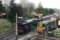 Unusually for December 2015, the weather was kind during a visit to the Mid-Hants Railway. 9F 2-10-0 92212 is on passenger duties at Alresford with 0-6-0 shunter 08377 (D3462) stabled in the loading dock siding. <br><br>[Peter Todd 28/12/2015]