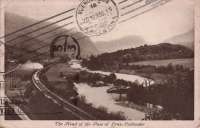 This postcard made its way to Argentina. An observation car (Maid of Morven perhaps?) can be seen on the rear of the Oban bound train, leaving the Pass of Leny and just shy of St Brides Crossing with Loch Lubnaig out of sight in the background. During the Second World War extensive sidings were laid out in the fields at St Brides.<br><br>[Ewan Crawford Collection //]