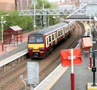 SPT liveried 320318 restarts a Helensburgh Central - Airdrie service from Coatbridge Sunnyside on 9 May 2005.<br><br>[John Furnevel 09/05/2005]