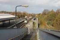 A view towards Birkenhead from the footbridge access to the Chester platform at Rock Ferry. On the far left are the bay platforms, now used for stabling. To the right of the platforms in use are the disused platforms on this former four track main line. Latterly freight only to Birkenhead Docks, it is clearly a long time since the tracks on the right were last used but the colour light signal is still lit. <br><br>[Mark Bartlett 16/11/2015]