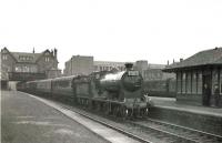 Admiring glances on the platform at Possil station on 17 June 1960 as NBR 256 <I>Glen Douglas</I> makes a photostop with the SLS/RCTS 'Scottish Rail Tour'. The 6-day tour, which had started from Edinburgh Waverley on 12 June, would end at Glasgow Central just over half an hour after this stop. A total of 11 steam locomotives were used during the tour, tickets for which cost £14. <br><br>[G H Robin collection by courtesy of the Mitchell Library, Glasgow 17/06/1960]