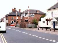 Between <I>The Railway</I> and <I>The Clayton Arms</I> stands Bedlington South signal box and level crossing. View east on 25 May 2004, with the former Bedlington station standing immediately to the left of the crossing [see image 22454] and Furnaceway Sidings off to the right beyond the box. <br><br>[John Furnevel 25/05/2004]