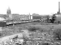 A DBSO leads an Edinburgh - Glasgow push-pull service past Haymarket East Junction on 28 April 1981, with the surrounding area undergoing demolition and clearance work. The propelling locomotive is 47708 <I>Waverley</I>. St Mary's Cathedral stands in the left background, with the 300 ft chimney of the Caledonian Distillery on the right. <br><br>[John Furnevel 28/04/1981]