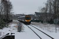 TPE 185146 cautiously approaches the Windermere terminus crossing Thwaites Lane bridge on a snowy 17th January 2016. The train is the 1202 arrival from Lancaster, the first train of the day on winter Sundays.<br><br>[Mark Bartlett 17/01/2016]