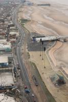 A <I>Flexity</I> tram heads south towards Blackpool Central Pier from the Tower tram stop. On this bitterly cold January day the promenade is quiet and presents a completely different picture from what would be seen in summer months. [See image 46461] for a ground level view of the same location.  <br><br>[Mark Bartlett 16/01/2016]