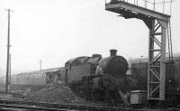 Steam heating the carriages at Cowlairs on a very dull afternoon on 24 February 1968 is Standard 2-6-4T no.80002. The loco survives and can be found today on the KWVR [See image 31925]<br><br>[John McIntyre Collection 24/02/1968]