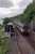 The carriage at Loch Awe which was home to Harry Watson (who is seen here to the left watching the passing train). This carriage is on a section of track installed by slewing the line over and then replacing the slewed section. The carriage later became the 'tea train' and now provides accommodation.<br><br>[Ewan Crawford //1991]