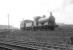 Looking west across the E&G near the top of the Cowlairs incline in the spring of 1952. An unidentified J36 0-6-0 is backing a brake van along the parallel Port Dundas branch heading for Craighall goods depot. [Ref query 1423] [See image 33527]<br><br>[G H Robin collection by courtesy of the Mitchell Library, Glasgow 08/04/1952]