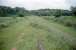 View south at Bridgend Junction in 1997 seen from the site of the signalbox. Here the M&K (right) met the North British's 1895 connection to the E&G at Waterside Junction (left). The box also served Auchengeich Colliery (1909-1965) to the south. Opening of this box and junction led to the closure of Garngaber Low Junction (at Muckcroft LC) where the single track lines from Middlemuir Junction and Garngaber High Junction met after running parallel for a considerable distance - the closure of Garngaber Low leading to an increase in that distance. Lines to Middlemuir and Waterside closed in 1959 leaving the original M&K the only line open until its closure in 1965. Pumping operations continued at Auchengeich until 1968 when Wester Auchengeich Colliery (nearby and served by Cadder Yard) closed.<br><br>[Ewan Crawford //1997]