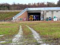 The 0945 Tweedbank - Edinburgh about to emerge from below the Edinburgh City Bypass during light rain on 24 January. The bridge surround has received some unwelcome attention from vandals of late. <br><br>[John Furnevel 24/01/2016]