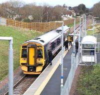ScotRail 158703 forming the Sunday morning 1045 Tweedbank - Edinburgh Waverley service, calls at Eskbank on 24 November 2016. The surviving platforms of the original Eskbank station are just visible on the other side of the A6094 road bridge in the distance.<br><br>[John Furnevel 24/01/2016]