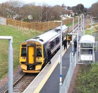 ScotRail 158703 forming the Sunday morning 1045 Tweedbank - Edinburgh Waverley service, calls at Eskbank on 24 November 2016. The surviving platforms of the original Eskbank station are just visible on the other side of the A6094 road bridge in the distance.<br><br>[John Furnevel 24/01/2016]