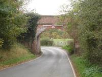 Immediately after the south end of Larpool Viaduct, which crosses the Esk Valley line on the approach to Whitby (Town) Station is a low narrow bridge crossing Larpool Lane at a blind bend, as seen in this view looking west in October 2015<br><br>[David Pesterfield 23/10/2015]