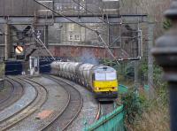 Since the turn of the year, cement traffic from Oxwellmains has been handled by Colas.  Their 60076 emerges from Haymarket North Tunnel into Princes Street Gardens with the empties from Aberdeen Craiginches on 19 January.<br><br>[Bill Roberton
 19/01/2016]