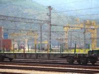 View from the station platform at Portbou over freight in the transhipment yard, showing the various gantry cranes for transhipping loads between standard and Spanish gauge rolling stock. Locos in the yard are Adif Bo-Bo shunter 311.126 on the left, an unidentified Renfe Mercancias electric loco partially hidden in the centre and SNCF Fret Bo-Bo shunter 469203 on the right.<br><br>[David Pesterfield 07/08/2015]