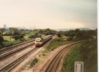 A viewpoint just West of the former station allowed me to watch this up HST heading for London at speed. The Bishton flyover to the right leads to Llanwern steelworks, left. For the other end of the steelworks [see image 1725].<br><br>[Ken Strachan 16/05/1987]