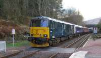 At the rear of the of the Oban –bound empty coaching stock due to form the sleeper to London Euston later in the evening, 73968 in ex-works condition contrasts sharply with the tired looking Virgin coach as the train leaves Dalmally on 14/2/16.<br><br>[Malcolm Chattwood 14/02/2016]