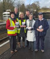 Under the ScotRail Deal  we are showing our appreciation of the hours volunteered by our hardworking station adopters through a quarterly prize-draw. The prizes are three pairs of Freedom of Scotland Travelpasses offering unlimited travel for eight days, and the first three winners are Alness, Bridge of Allan and Renton. Seen here with chairman Elizabeth Rankin (centre left) are the Friends of Bridge of Allan celebrating what could just be the first day of spring.<br><br>[John Yellowlees 17/02/2016]