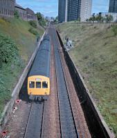 101.340, on the way to Dunblane, climbs up the Cowlairs incline in 1987. The remains of the Pinkston Iron Works are on the right. This stretch of the incline used to be crossed by a road bridge and a link between the NBR's Pinkston branch and the CR's St Rollox Goods West.<br><br>[Ewan Crawford //1987]