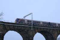 On a cold February afternoon, a Glasgow - Edinburgh DMU at speed passes the first set of OHLE masts to be fitted to the previously installed support brackets on the viaduct.<br><br>[Colin McDonald 13/02/2016]