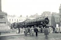 A group of admirers gathers in George Square, Glasgow, in September 1950. The centre of attention is Indian Railways 2-8-2 locomotive no 8324, built at the nearby Queens Park Works.   <br><br>[G H Robin collection by courtesy of the Mitchell Library, Glasgow 21/09/1950]