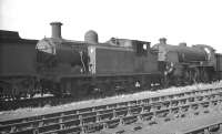 Locomotives awaiting disposal at Eastleigh in the autumn of 1963 include Billinton E4 0-6-2 Radial tank 32557 of 1901. Withdrawn from Nine Elms at the end of 1962 it was cut up here shortly after the photograph was taken. Beyond is Urie S15 4-6-0 30515, which ended its operational days at Feltham in July that year. Disposal took place here the following January.<br><br>[K A Gray 25/09/1963]