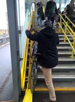 Yet more new technology for bikes [see image 40960]. This steel channel alongside the footbridge steps at Cambridge leading up from platform 4 (view looks North) offers a handy alternative to squeezing your bicycle into a lift.<br><br>[Ken Strachan 20/02/2016]