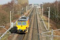 A Colas track machine, heading from Crewe to Warrington, heads north on the WCML near Acton Grange Junction on 26th February 2016. At the junction ahead the line from Chester trails in before the tracks cross the Manchester Ship Canal and then divide for Arpley Yard and Bank Quay station. [Ref query 6388]<br><br>[Mark Bartlett 26/02/2016]