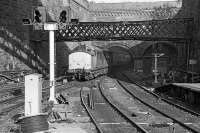 37413 emerges from a fume-filled tunnel into a very untidy Glasgow Queen Street station on a warm day in June 1986, hauling a late running train from Fort William. Signalling work is in progress. The latticed girders once supported the station signal box until its abolition in 1967.<br><br>[Mark Dufton /06/1986]