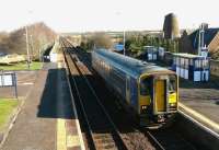 Sprinter <I>bubble car</I> 153331, on a Northern service from Carlisle to Workington and the Cumbrian Coast, calls at Wigton on 15th February 2016. The distinctive building just beyond the platforms is an old windmill on the edge of the town. <br><br>[Brian Smith 15/02/2016]