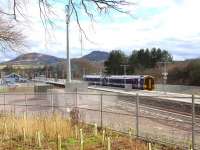 View south at Tweedbank on 6 March 2016 with ScotRail 158730 accelerating away from the lengthy platform. On the left is the train crew building, which carries the name 'Eildon View' and, in the background, the reason why it carries the name. The train is the 1245 Sunday service to Edinburgh Waverley, scheduled to arrive there at 1340. <br><br>[John Furnevel 06/03/2016]