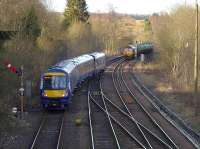 170 460 eases out of Dunblane loop in preparation for reversal and <br>
then a return to Edinburgh. DBS 66111, with empty tanks from Lairg to Mossend, waits patiently for these manoeuvres to be completed.<br>
<br><br>[Bill Roberton 27/02/2016]