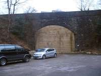 View north east at the bricked up south portal of the very high Heys Road over-bridge at Thongsbridge near Holmfirth, beyond which new housing is being built in the deep cutting running to the nearby Springwood Road over-bridge. The roofs of those by the bridge can just be seen rising above the parapet. Other than the A616 rail overbridge near Brockholes, these two bridges are the only other structures extant on the former Holmfirth branch in March 2016. <br><br>[David Pesterfield 03/03/2016]