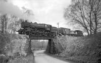 A photograph taken with a Brownie 127 camera in March of 1965. It shows the local pick-up goods being propelled towards Langholm over the Broomholm Bridge, south of the terminus. The locomotive is Kingmoor's Ivatt 2-6-0 43049.<br><br>[Bruce McCartney 29/03/1965]